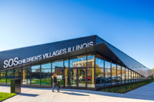 A swooping angular roofline with a SOS Children’s Villages Illinois sign