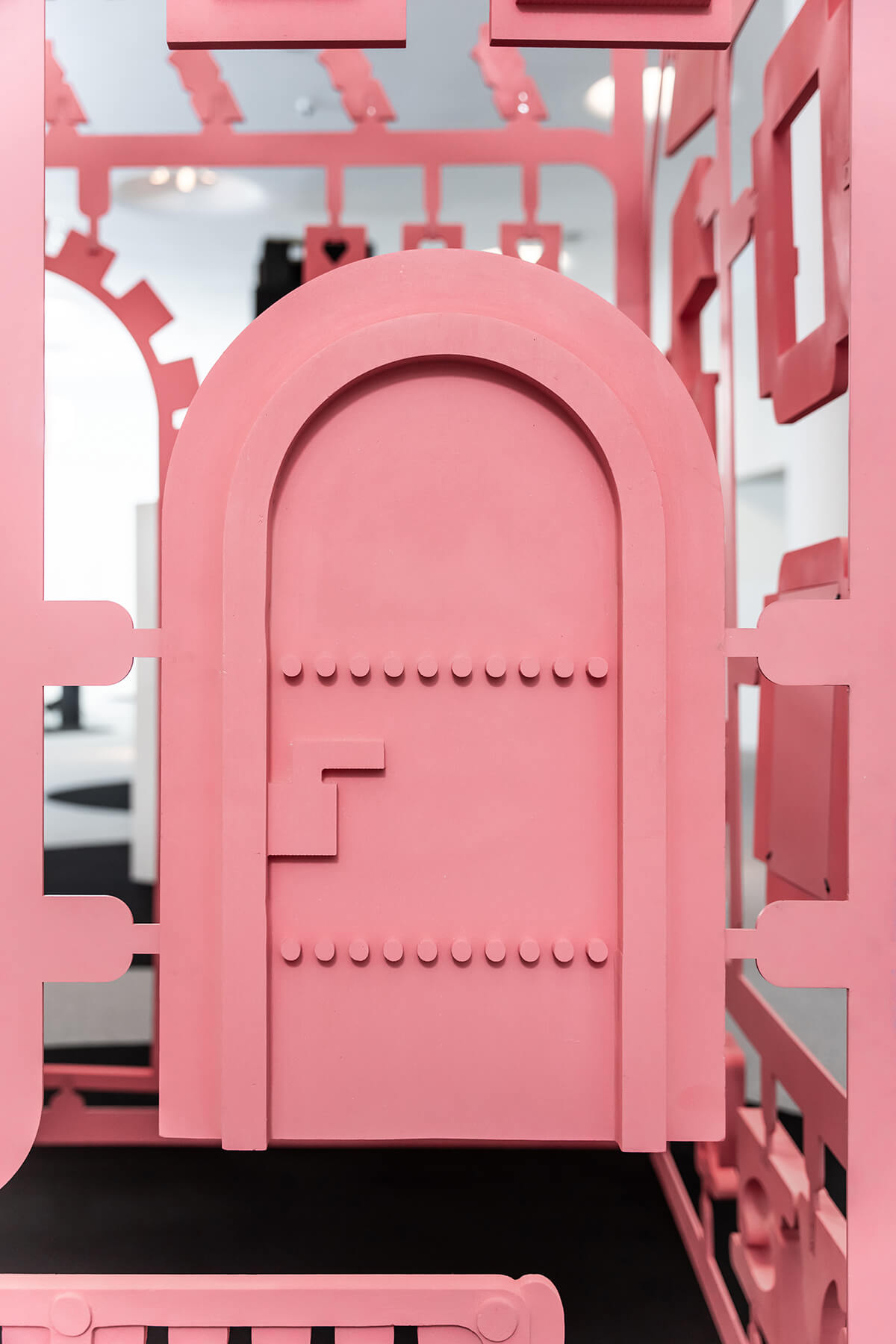 a coral-painted, chalet-inspired installation at an exhibition