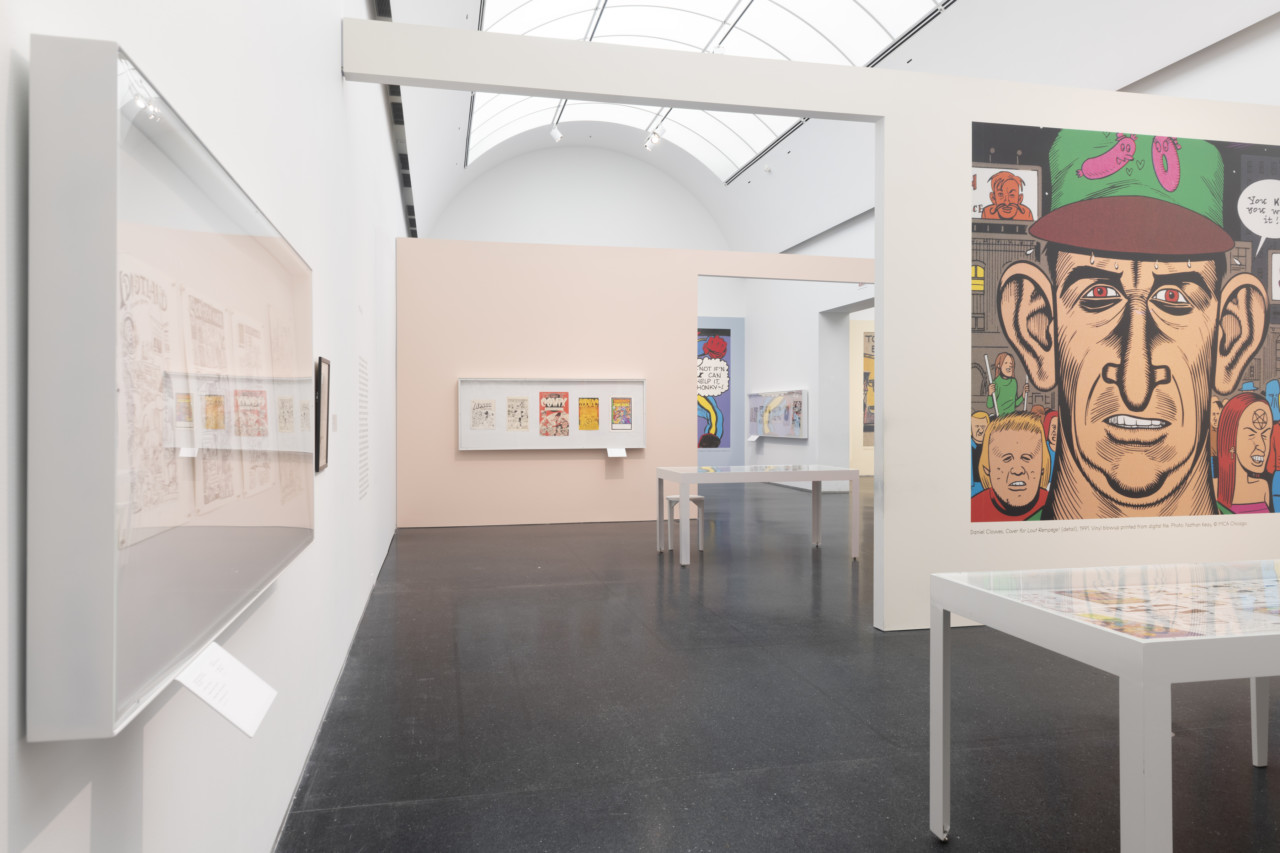 interior photograph of a museum gallery with comic strips set in vitrines