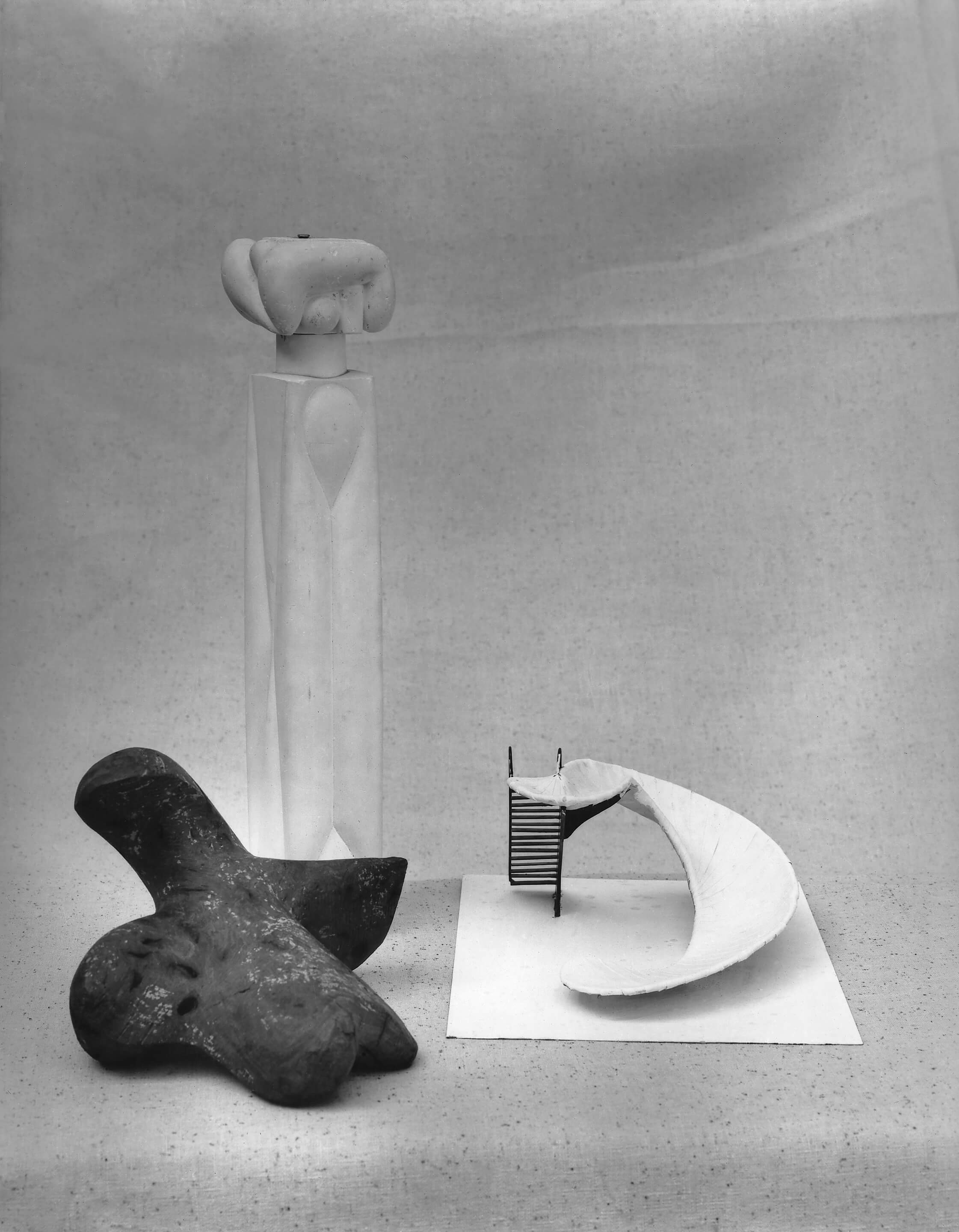A collection of sculptural maquettes in a black and white photo