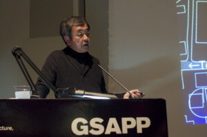 kengo kuma giving a lecture from a podium