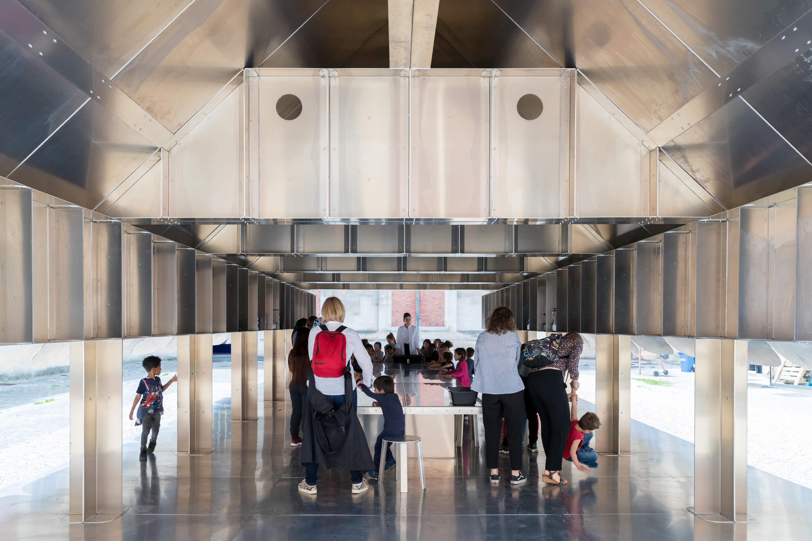 Inside a school by MOS decked out in stainless steel walls and ceiling