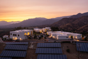 photo of the ojai valley school, a collection of white buildings on a hilltop at dusk