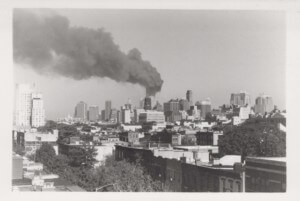 The smoking world trade center, in black and white, as seen from brooklyn