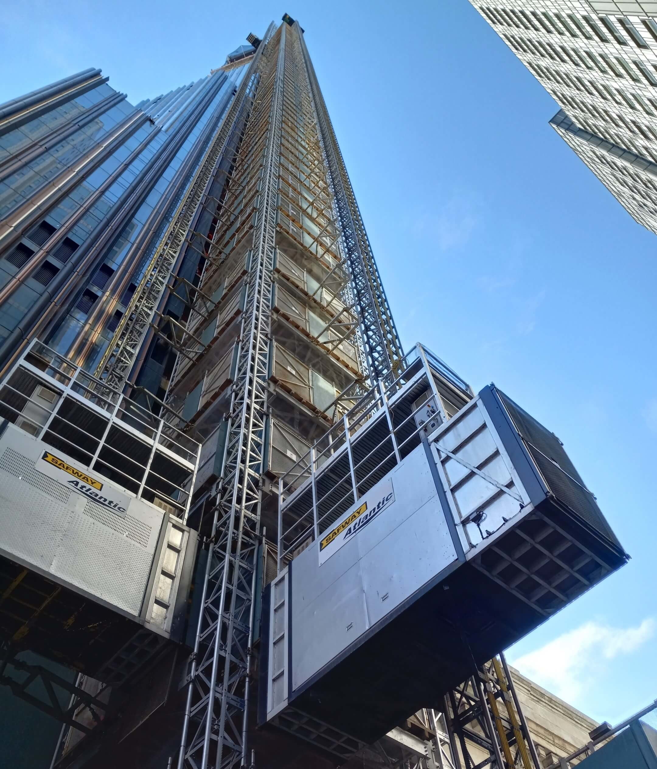 looking up at a construction elevator and skyscraper
