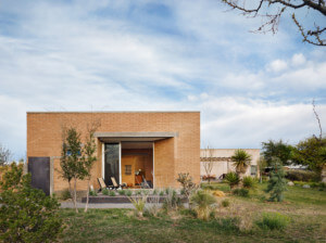The marfa suite, a squat brick dwelling against the sky