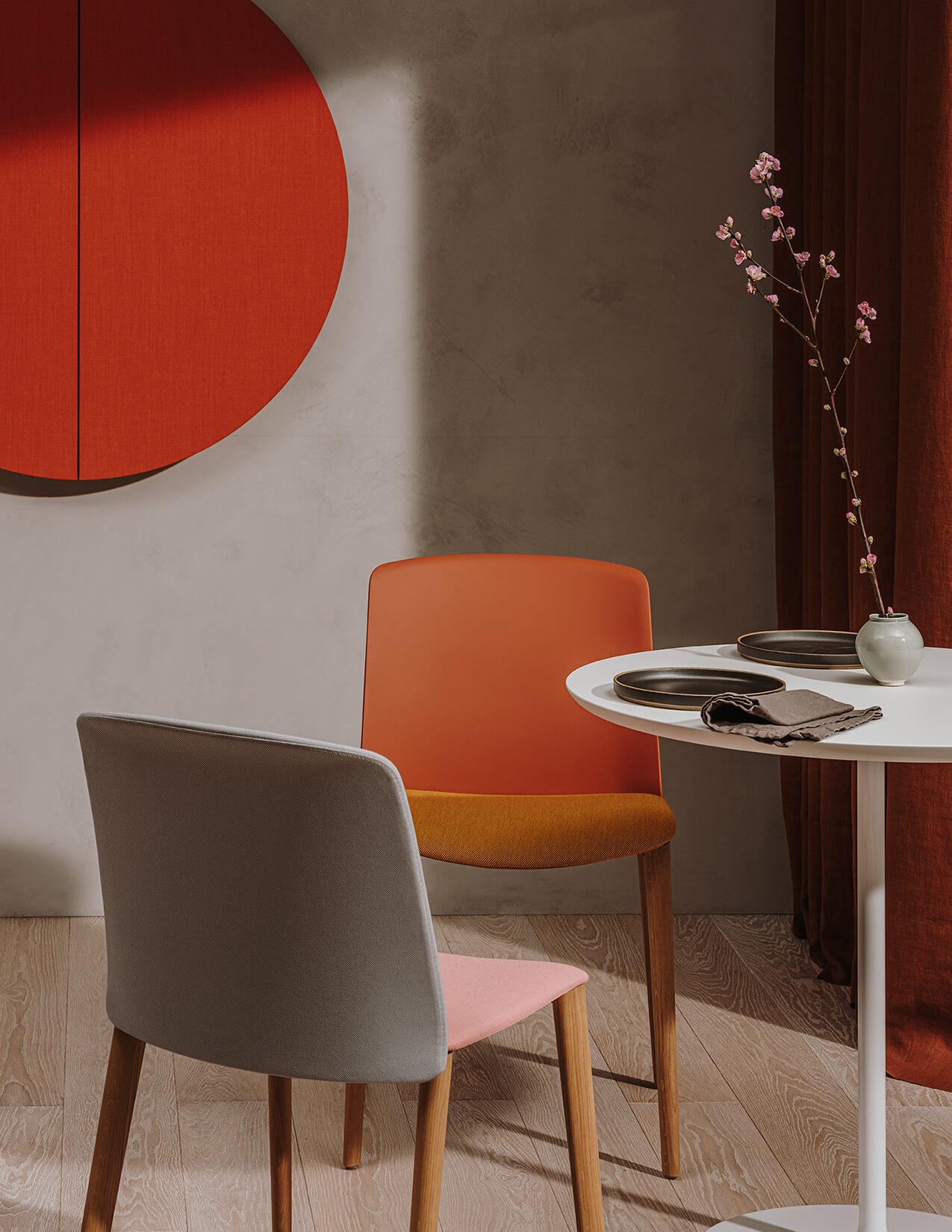 chairs, a table, and circular acoustic panel in an interior