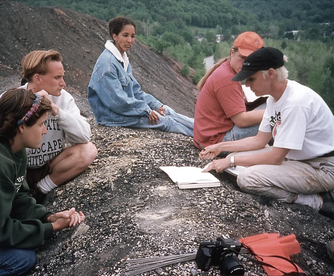 1990s era photo of a group meeting at an old industrial site