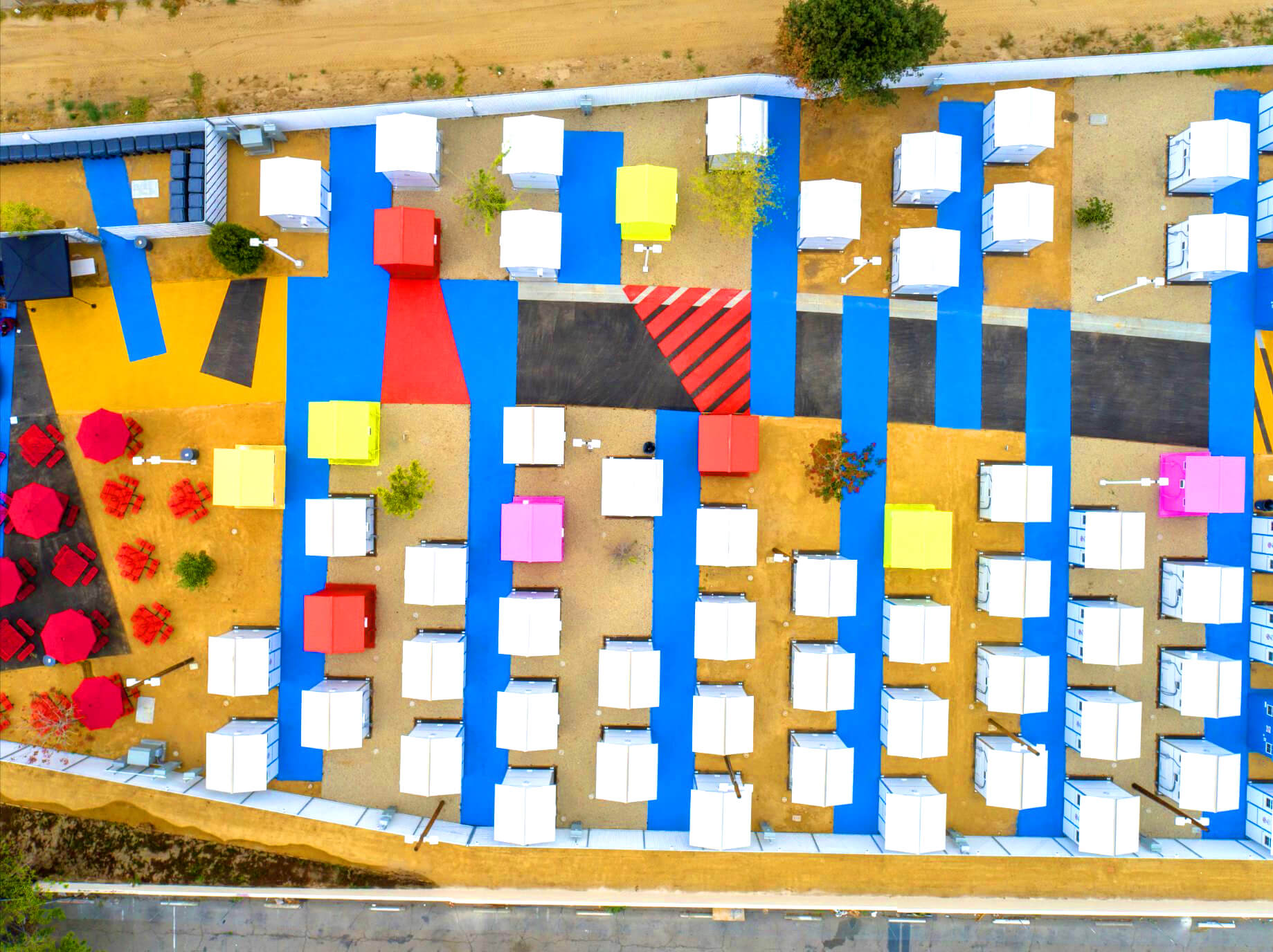 aerial view of a colorful tiny house village in los angeles