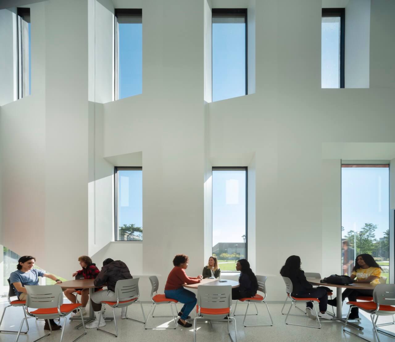 Students by large white windows
