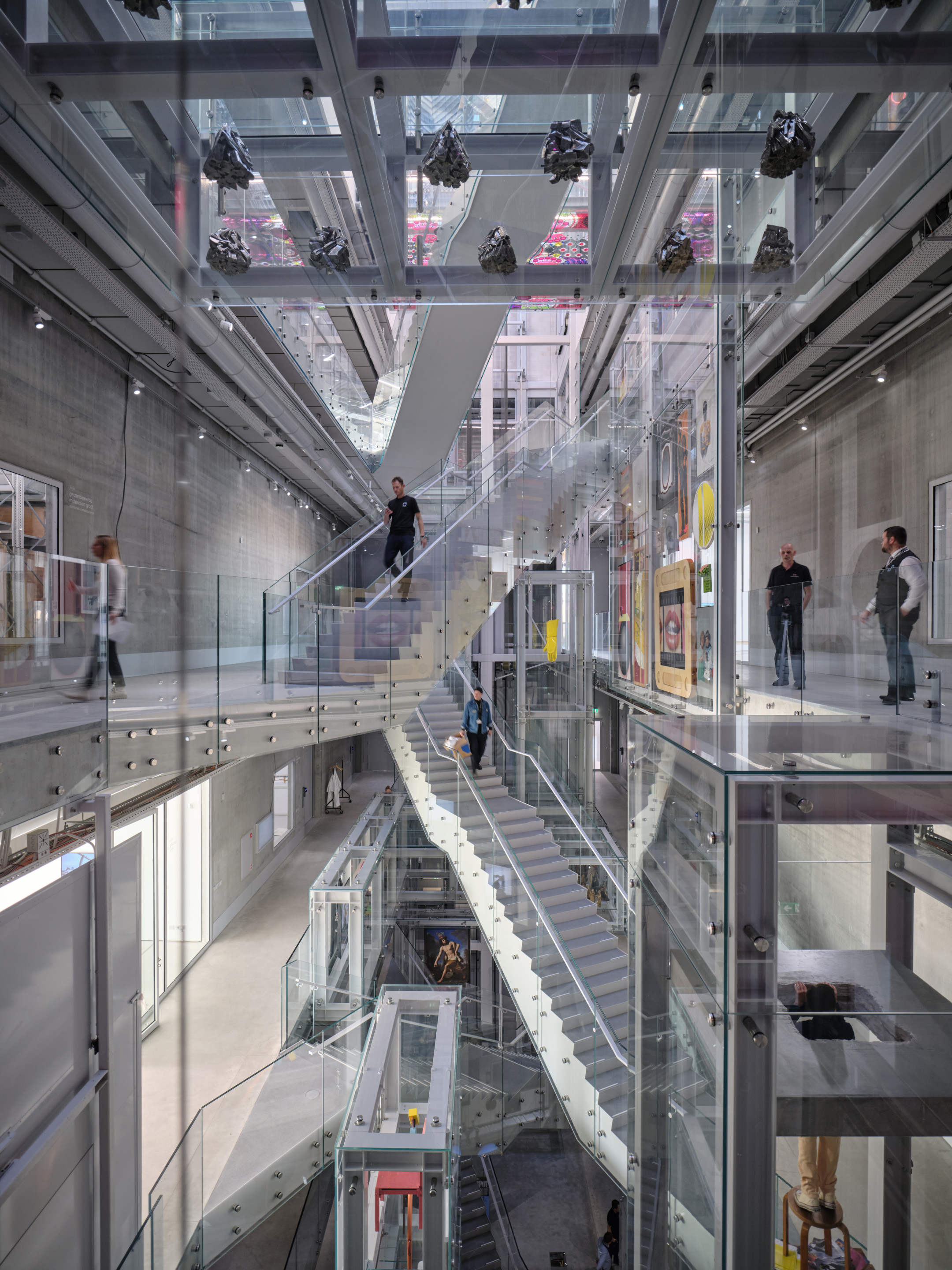 people view art storage organized around an atrium with criss-crossing staircases
