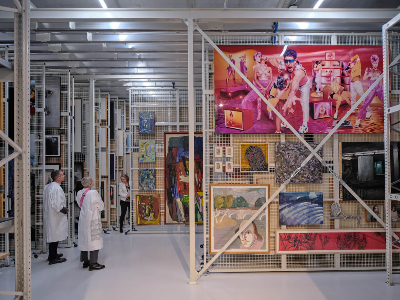 people admire artworks in an open storage facility