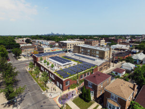 overhead rendering of a brick building with a rooftop garden for blue tin