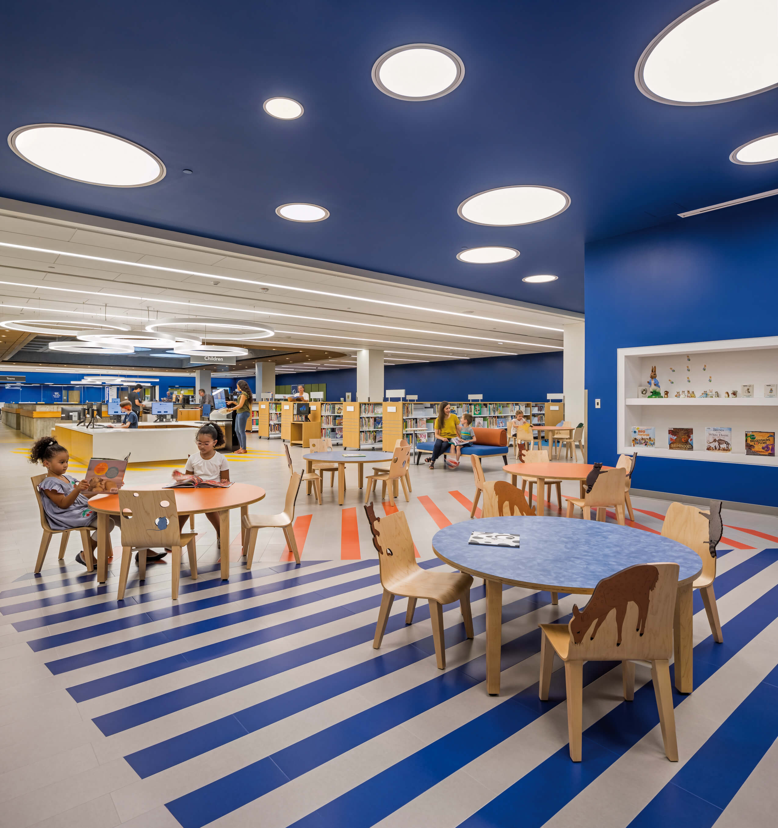 a children's section in a library with bright blue colorway