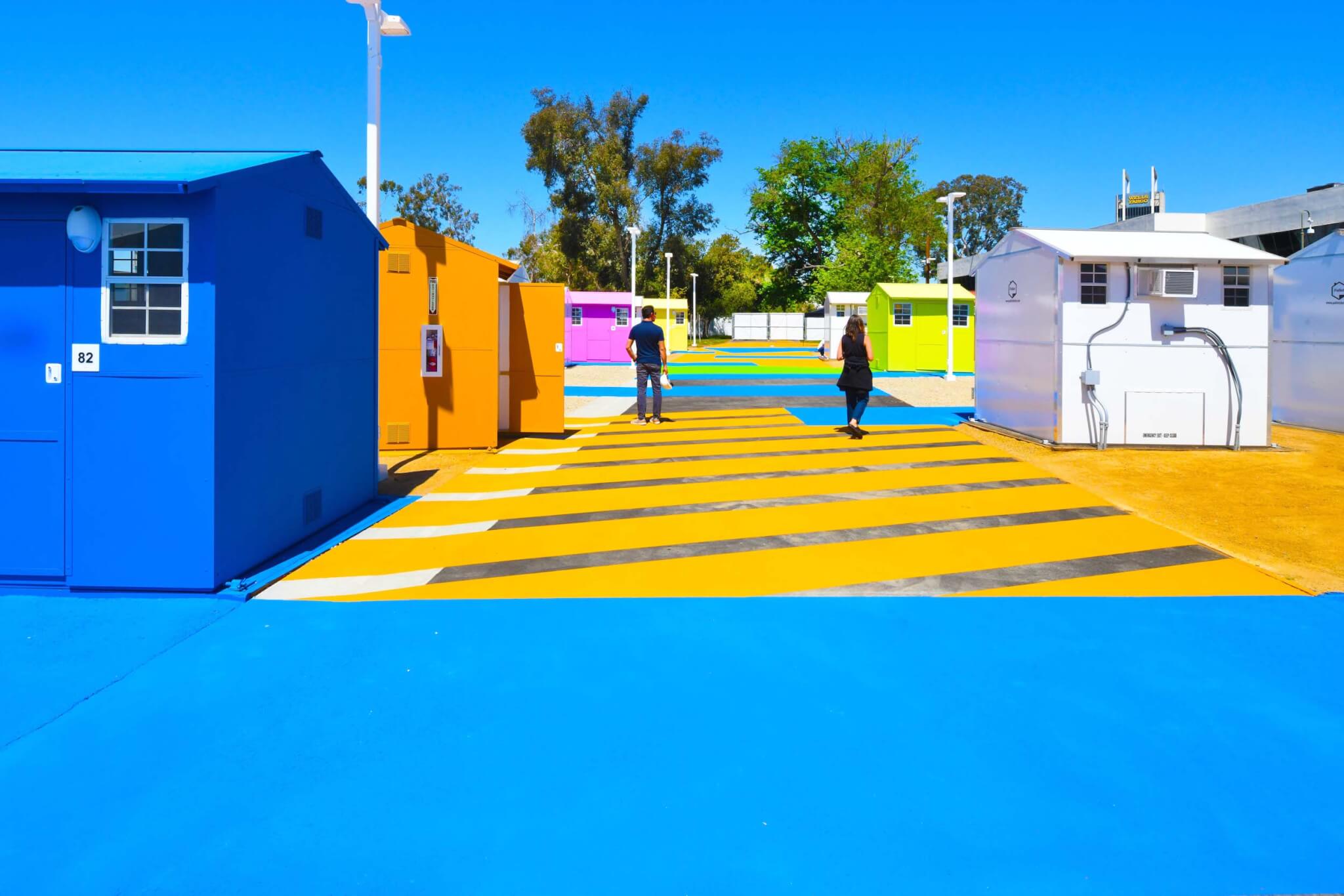 bright blue and yellow supergraphics at a tiny house village