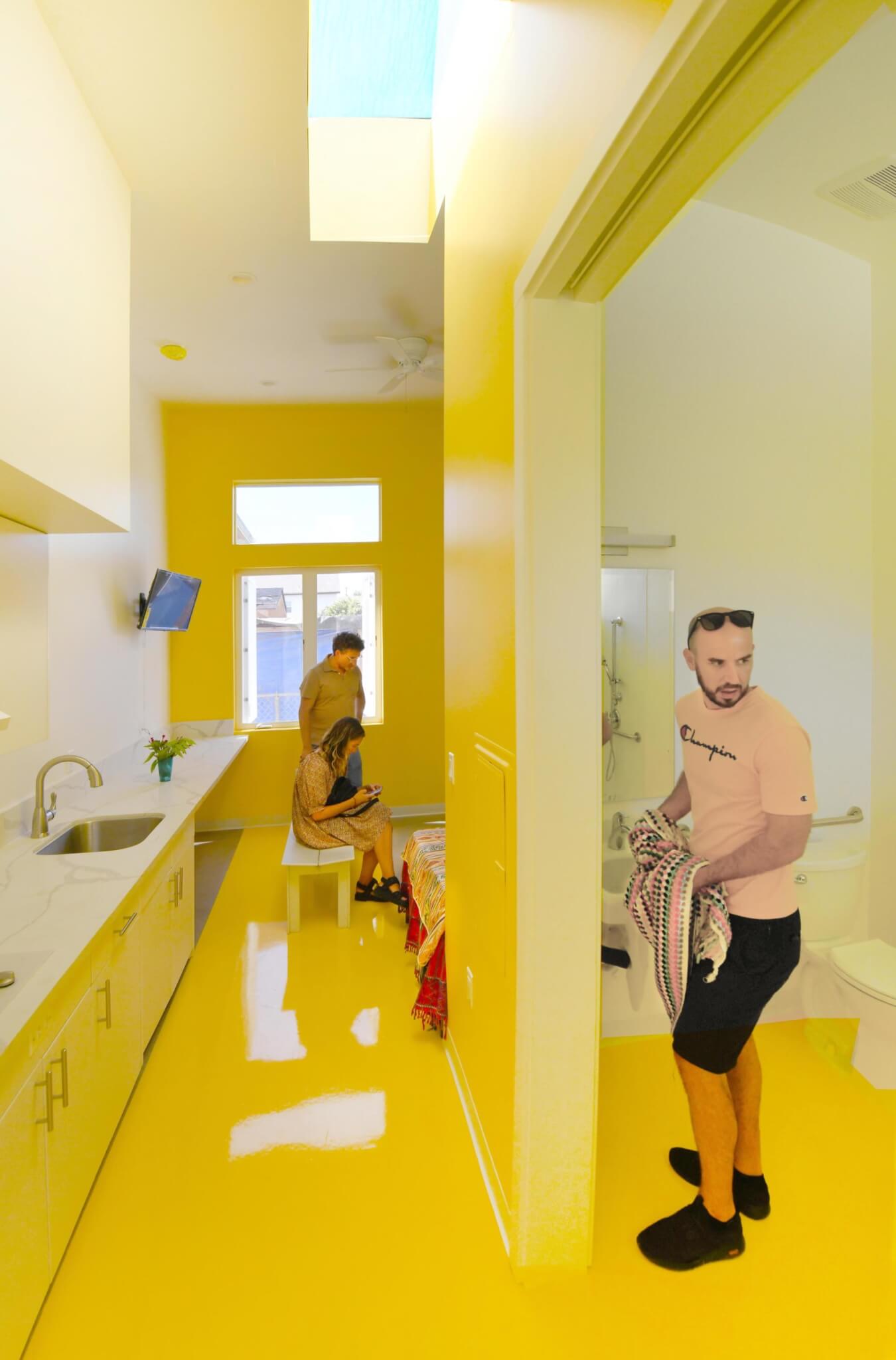 inside a small residential unit painted bright yellow