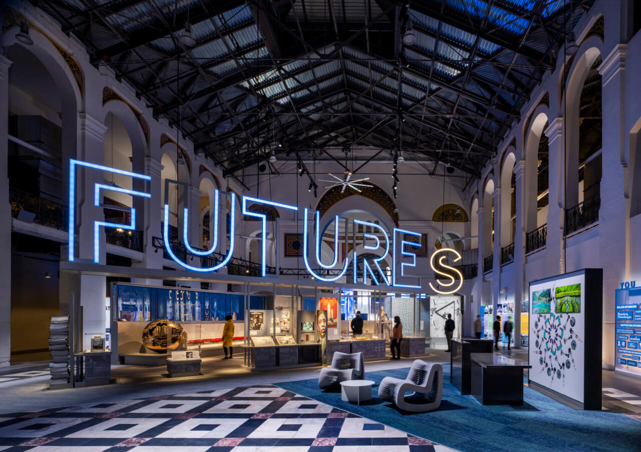 installation view of a major smithsonian exhibition with a neon FUTURES sign