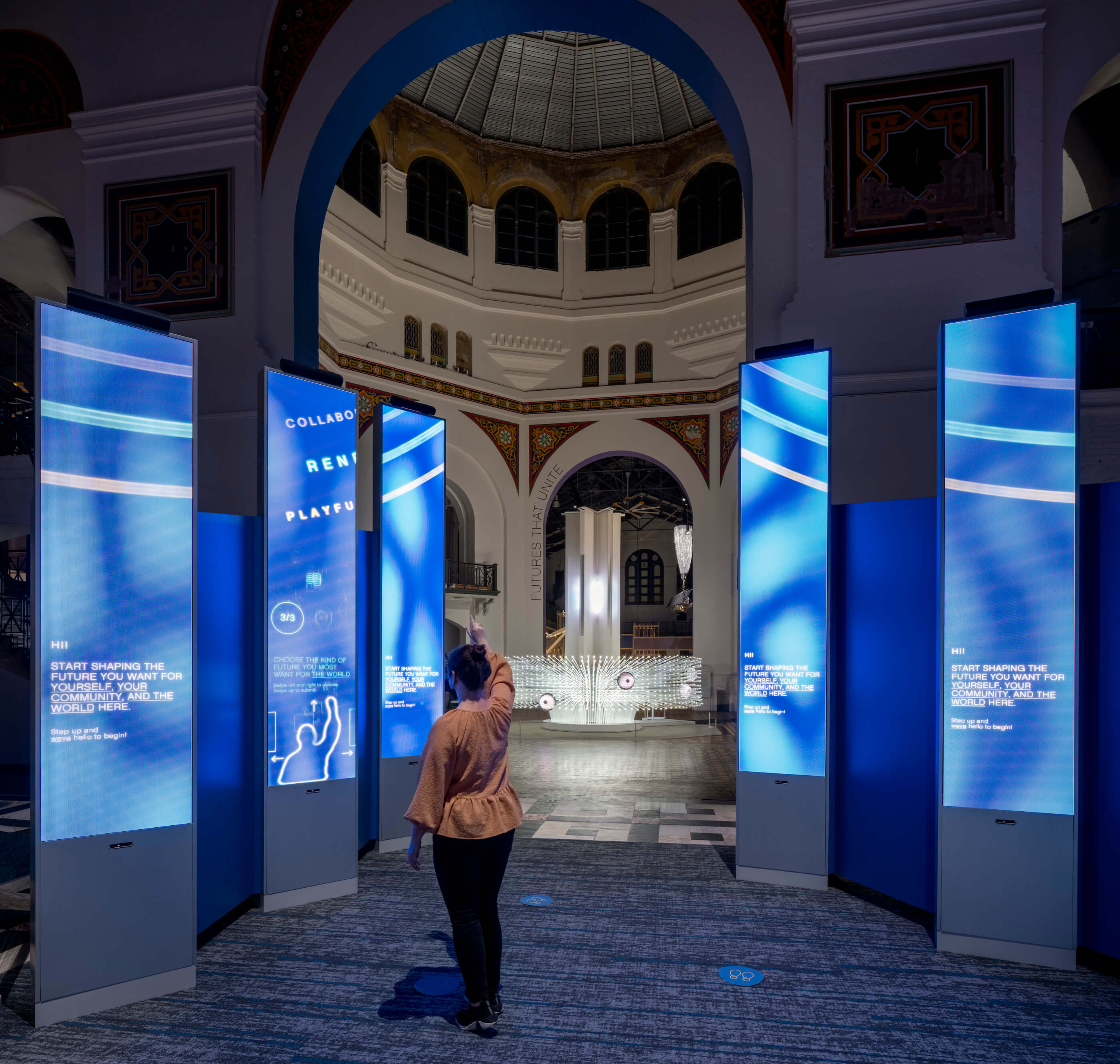 installation view of a major smithsonian exhibition about the future with interactive display screens