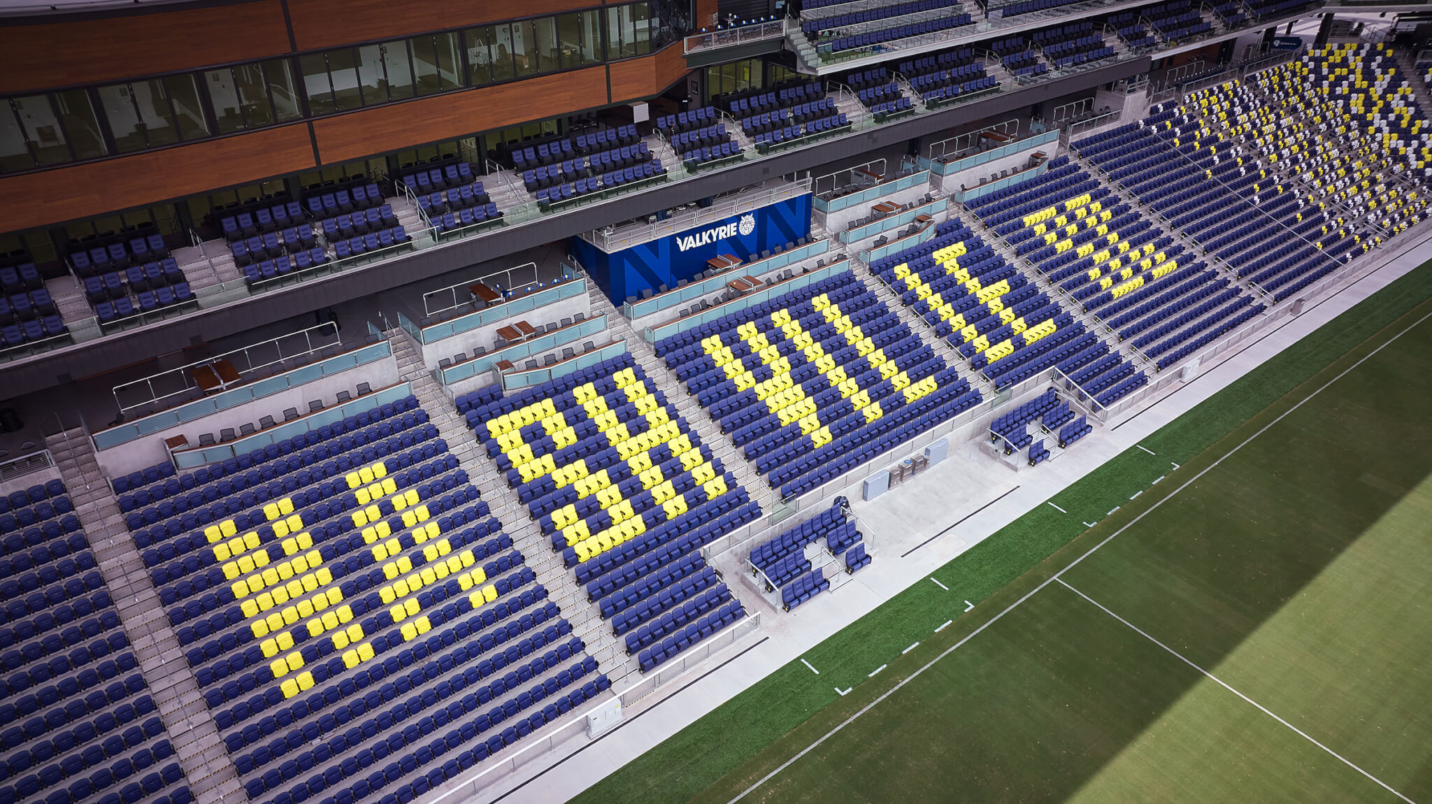 overhead view of seating at a soccer stadium with NASHVILLE SC spelled out in yellow