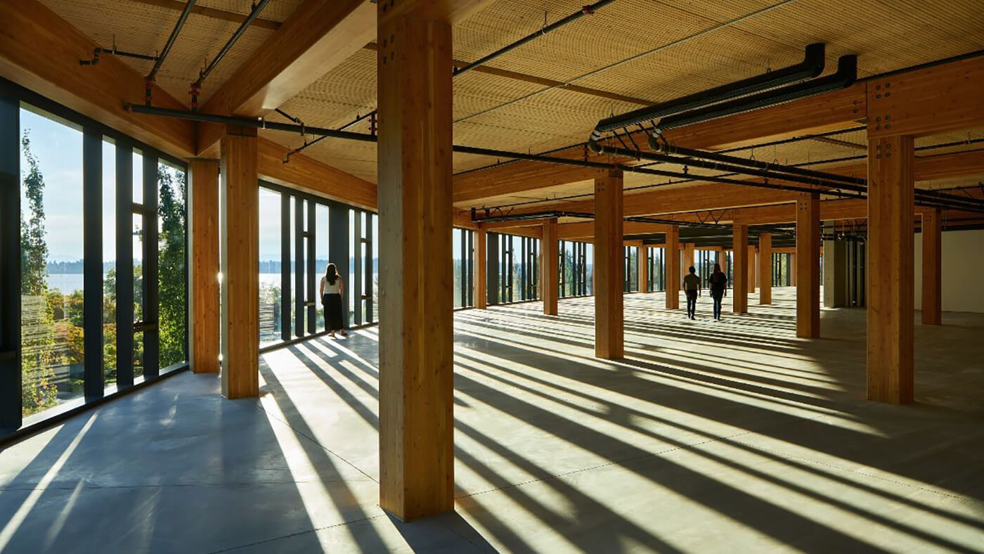 inside a large open office space with timber beams and ceiling