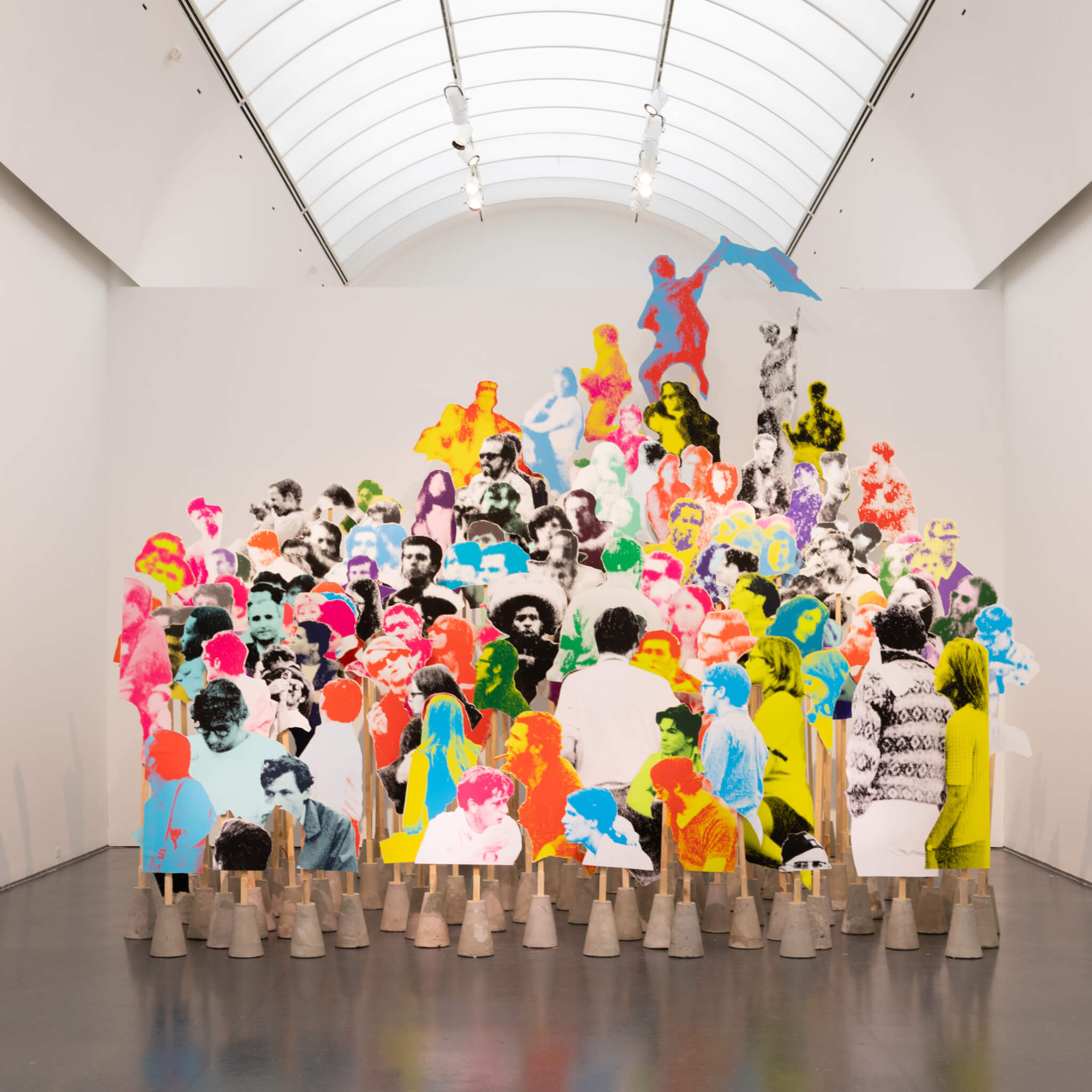 an art installation depicting a group of assembled people