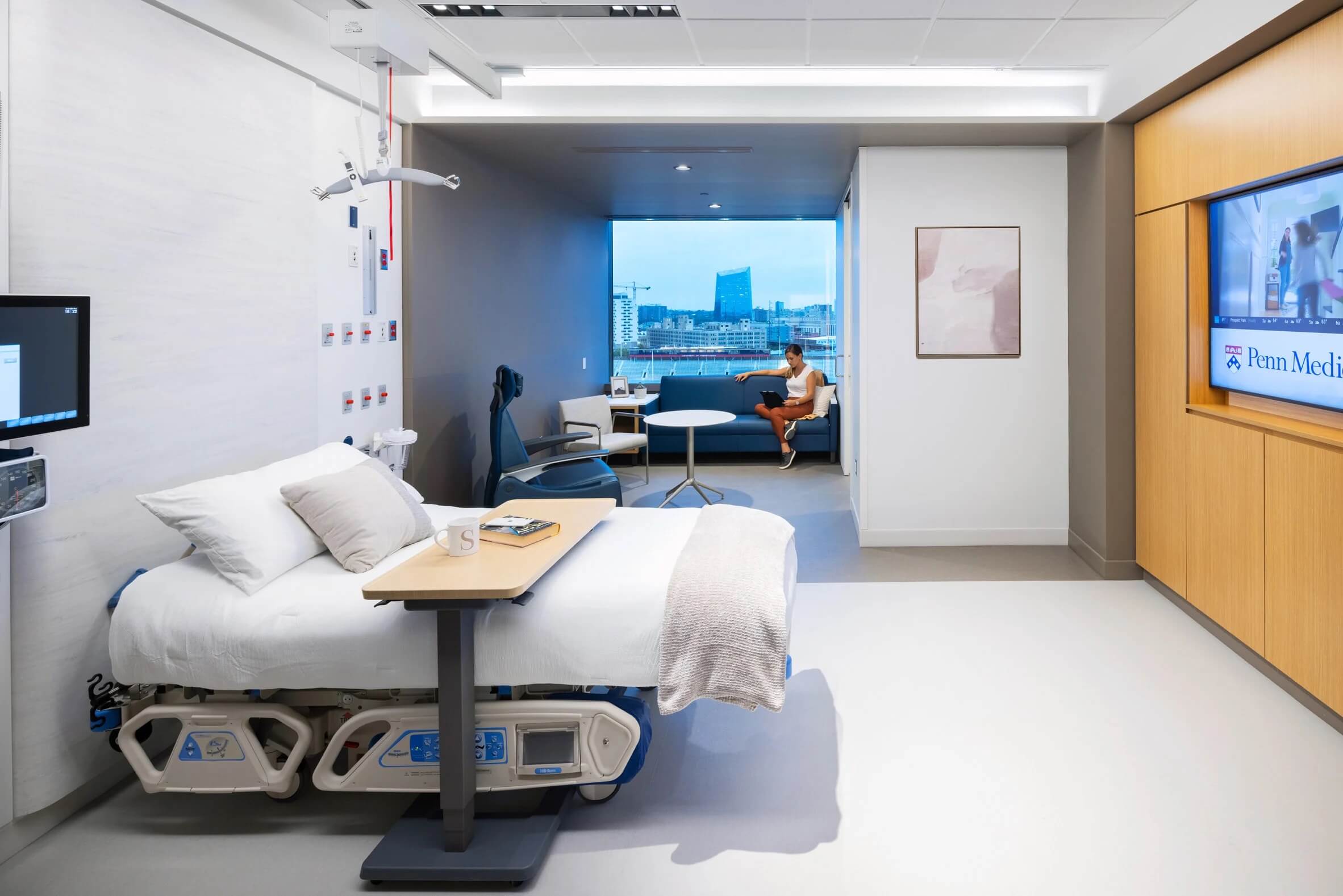 a spacious hospital room with city views