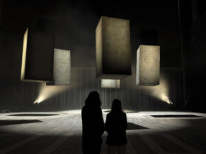 Large concrete cubes dancing in a hall