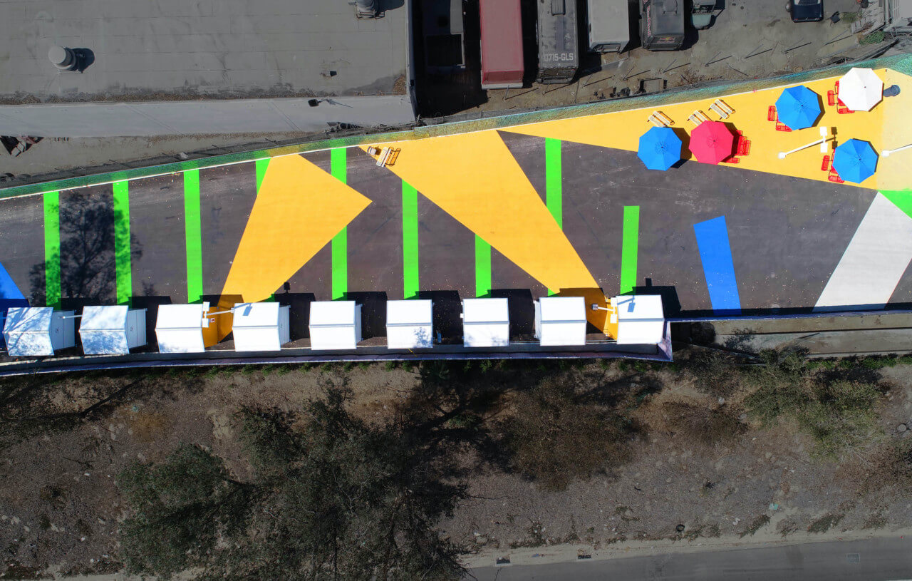 aerial view of tiny homes and brightly colored environmental graphics