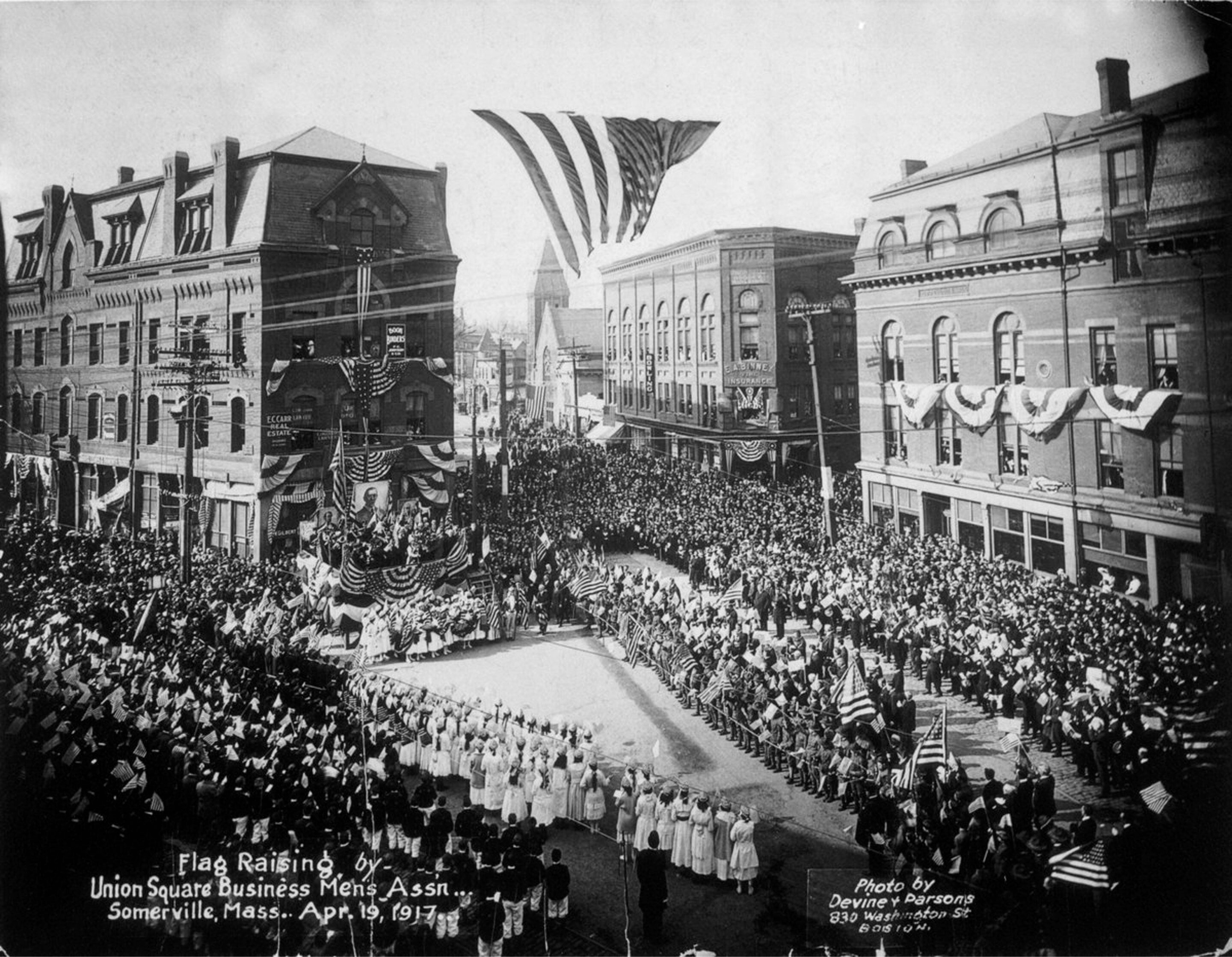 a black and white photo of a flag raising