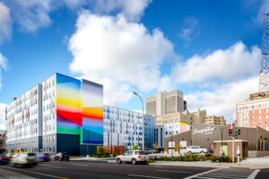 view of a mixed-use development with a large, colorful mural