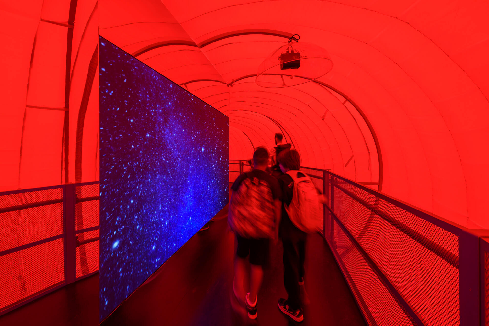 red-illuminated pathway in a exhibition space