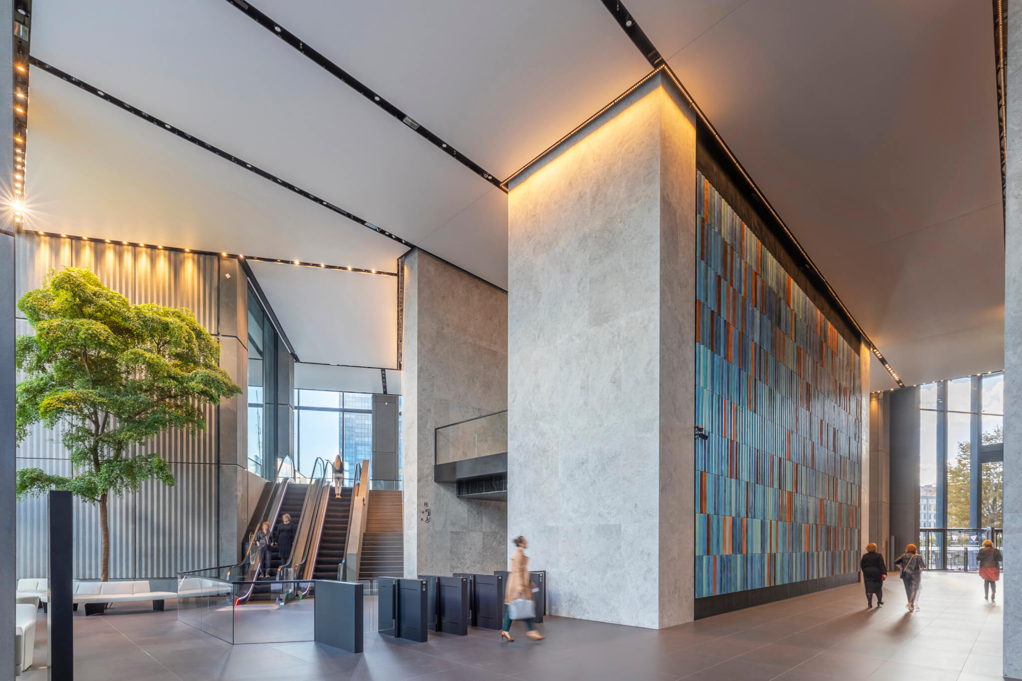 view of an office building lobby with a large artwork