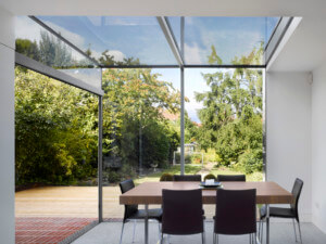 a dinning room in a room with glass walls and a glass ceiling