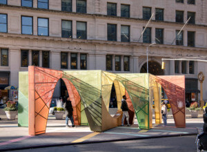 a long metal pavilion made of steel and colorful cord