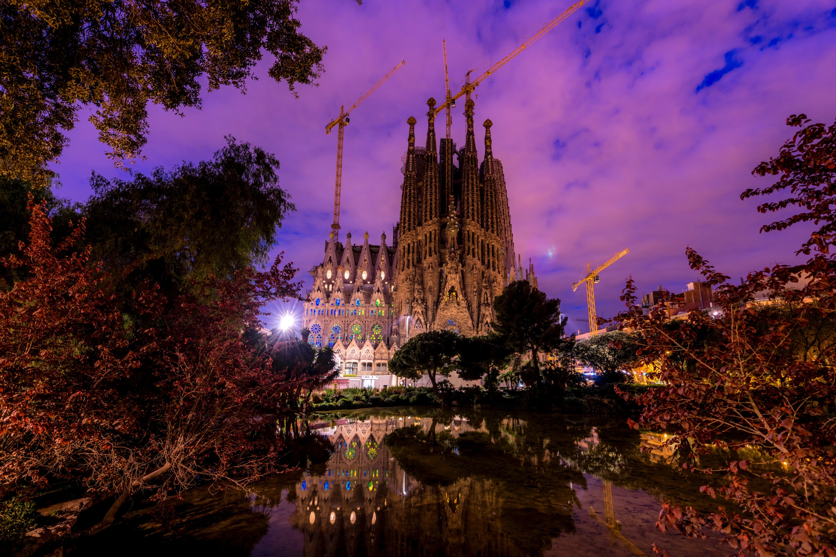 The Sagrada Família, a heavily decorated basilica, at night