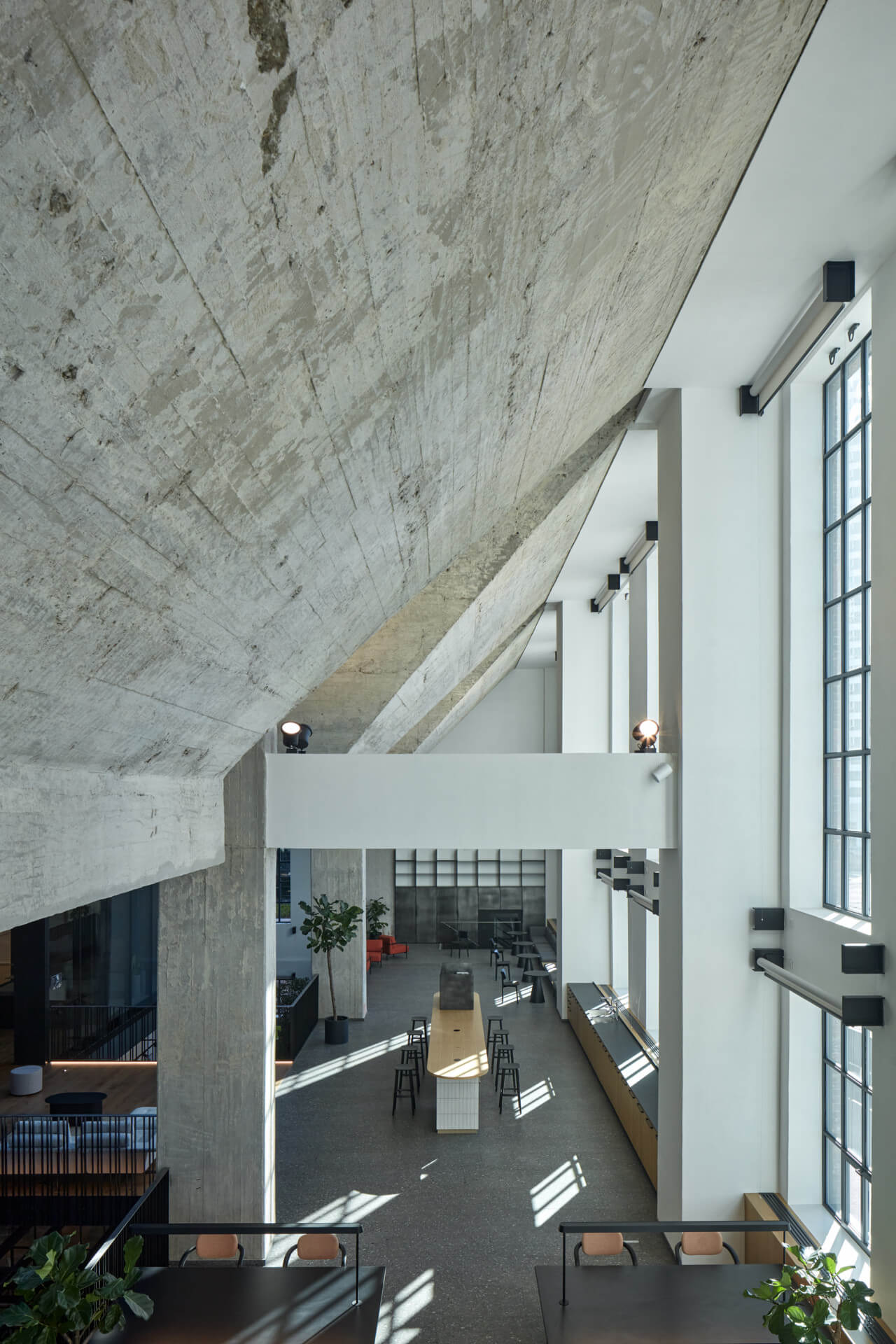interior of an office with large hanging concrete volumes