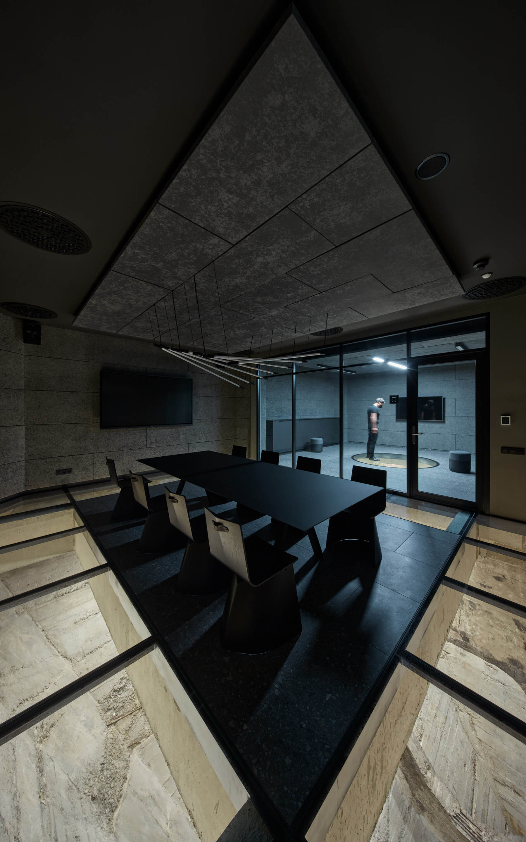 A meeting room inside of a concrete hopper with glass floors