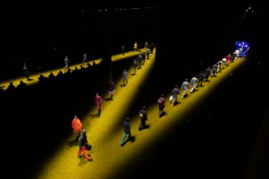 Models walking a zigzagging runway for the Prada 2022 menswear show