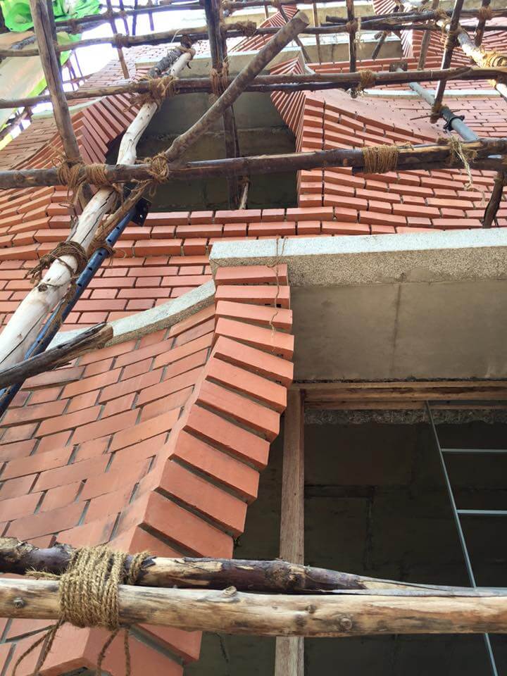 Scaffolding in place while twisting brick rises