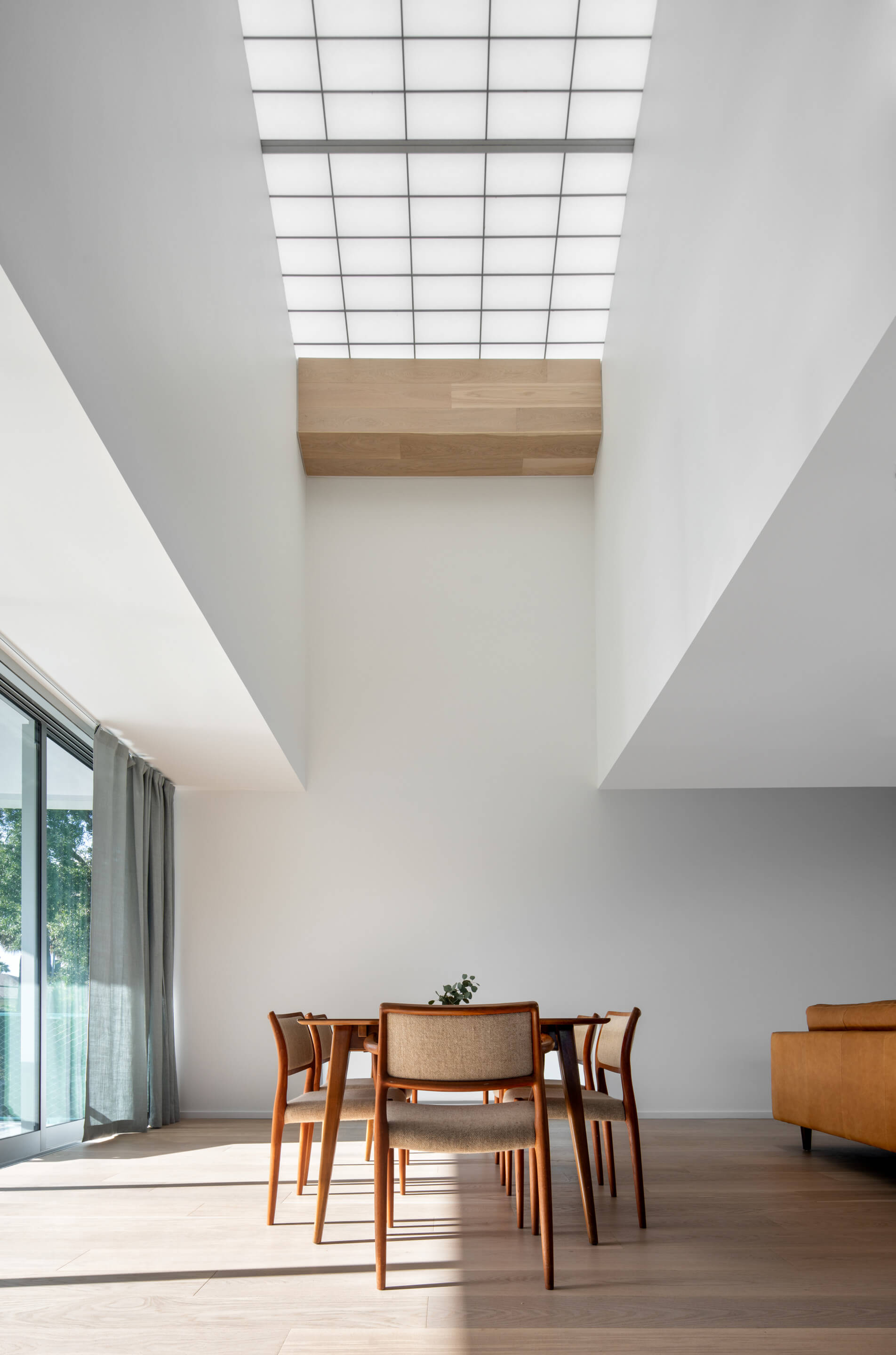 A very tall skylight above a dining table in the Five Twelve House 