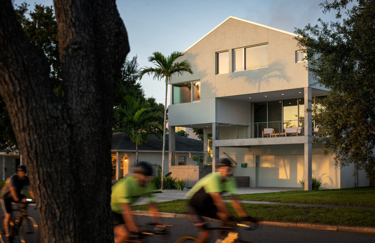 The Five Twelve House, an elevated white home on the waterfront