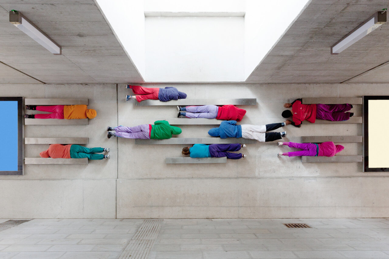a performance of bodies in space with people wedged into shelves