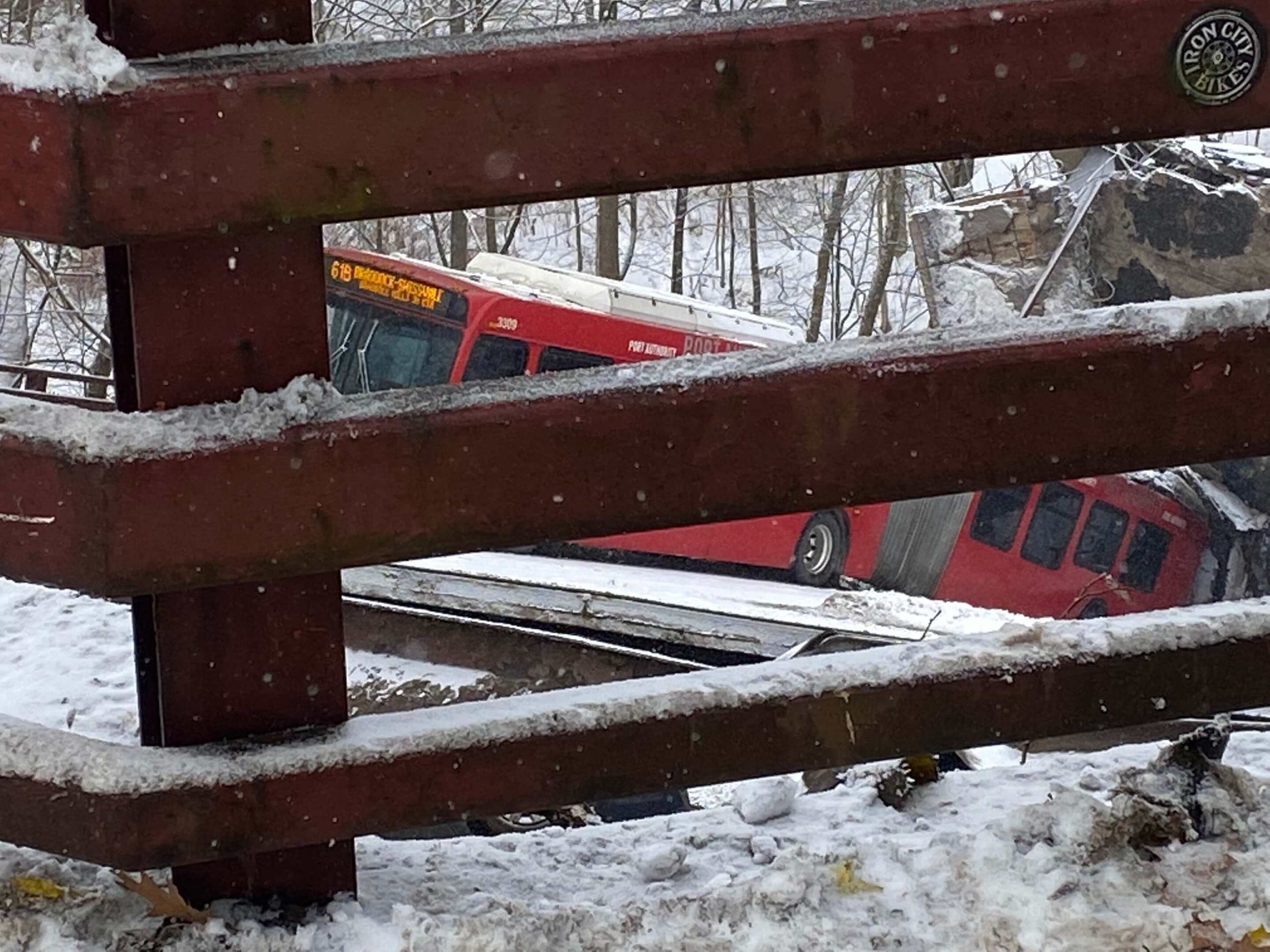 bus dangling from a collapsed bridge
