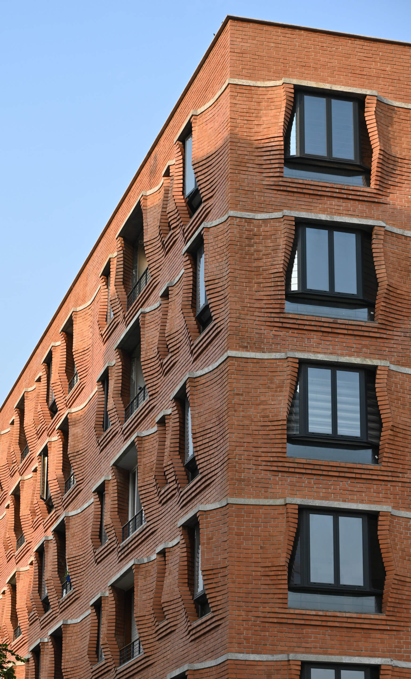 A towering brick apartment complex with corbeled brick called Sienna