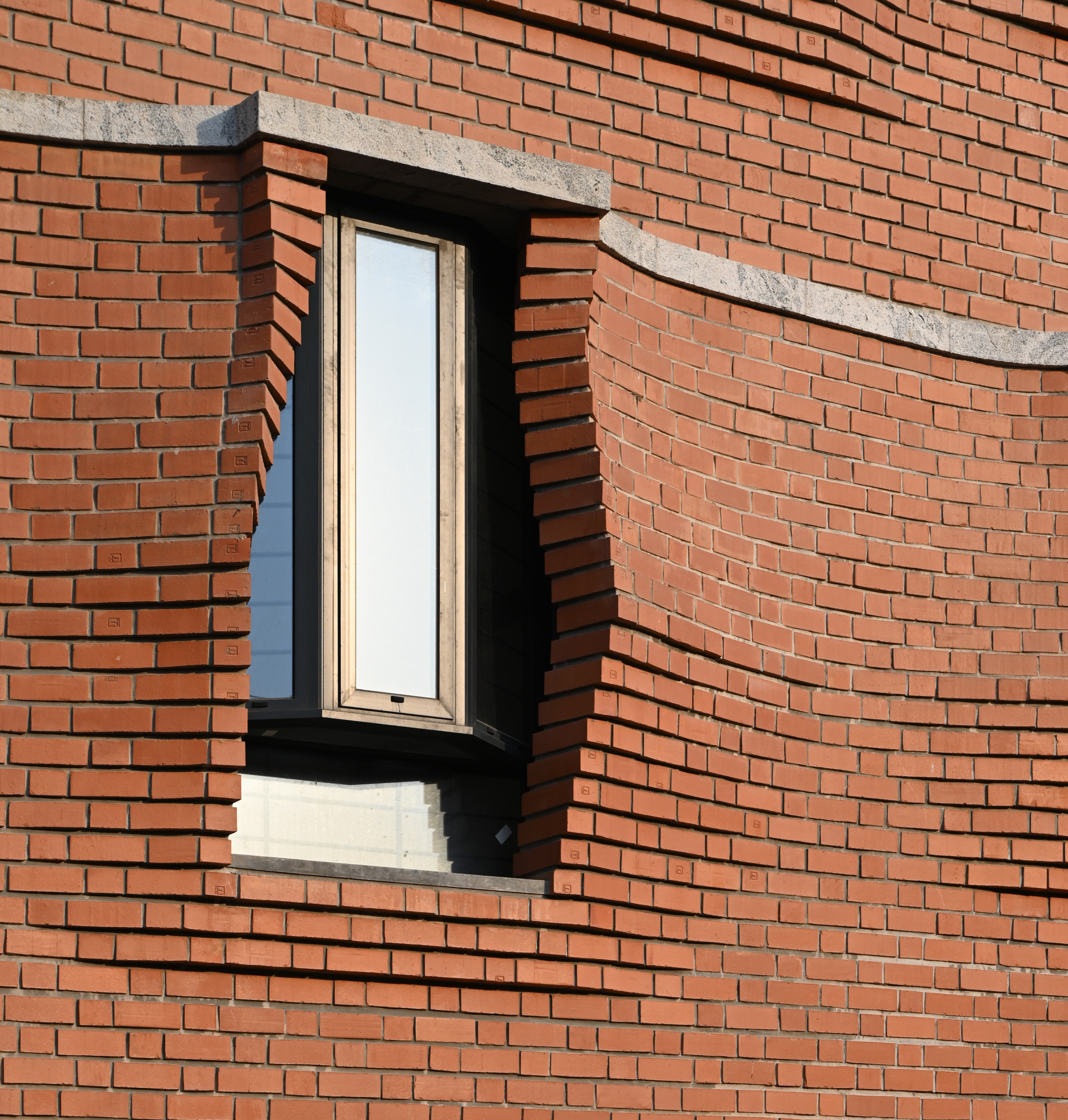 A floating window amid parting brick at the sienna