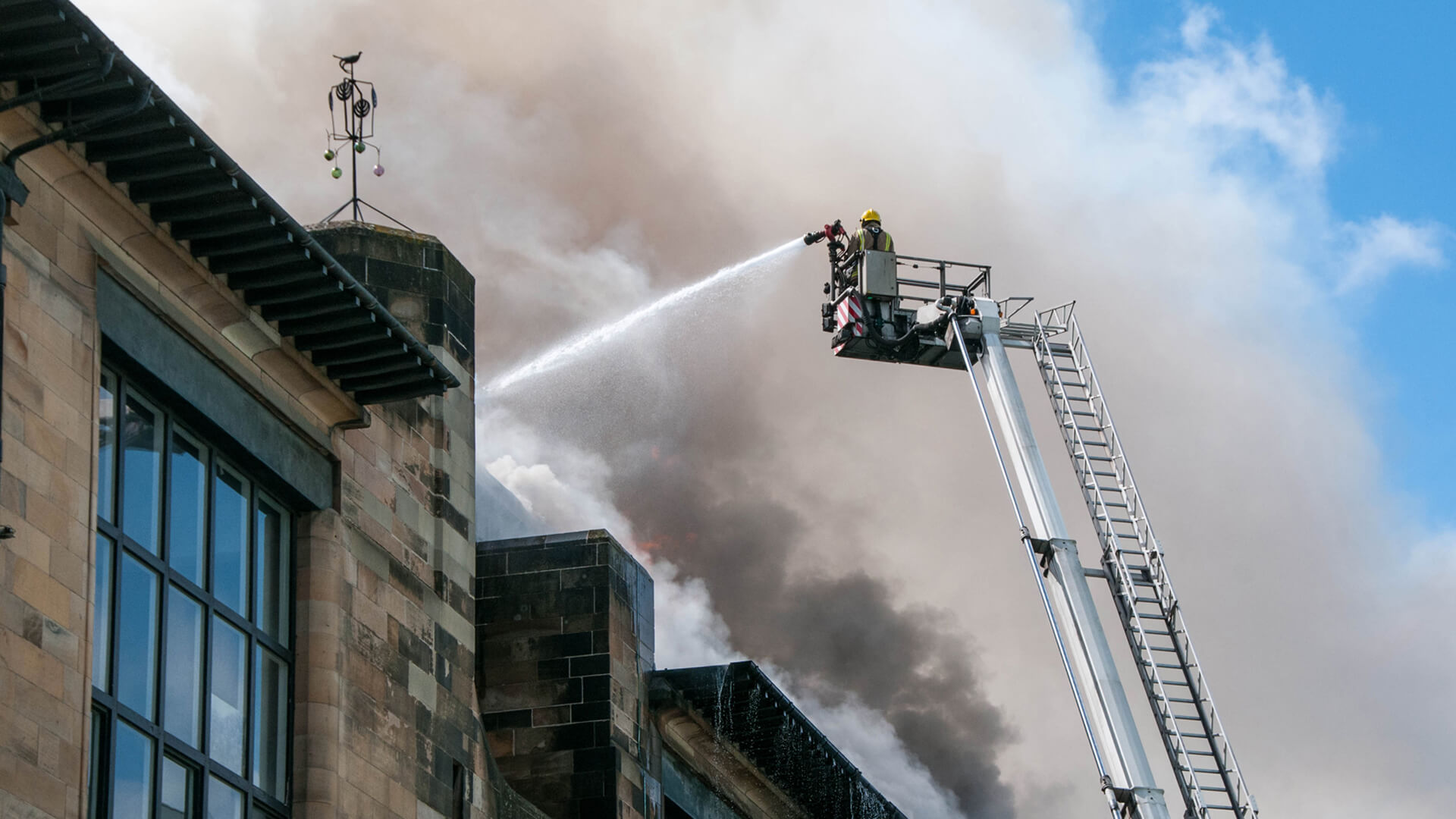 firefighters battle a building blaze from above