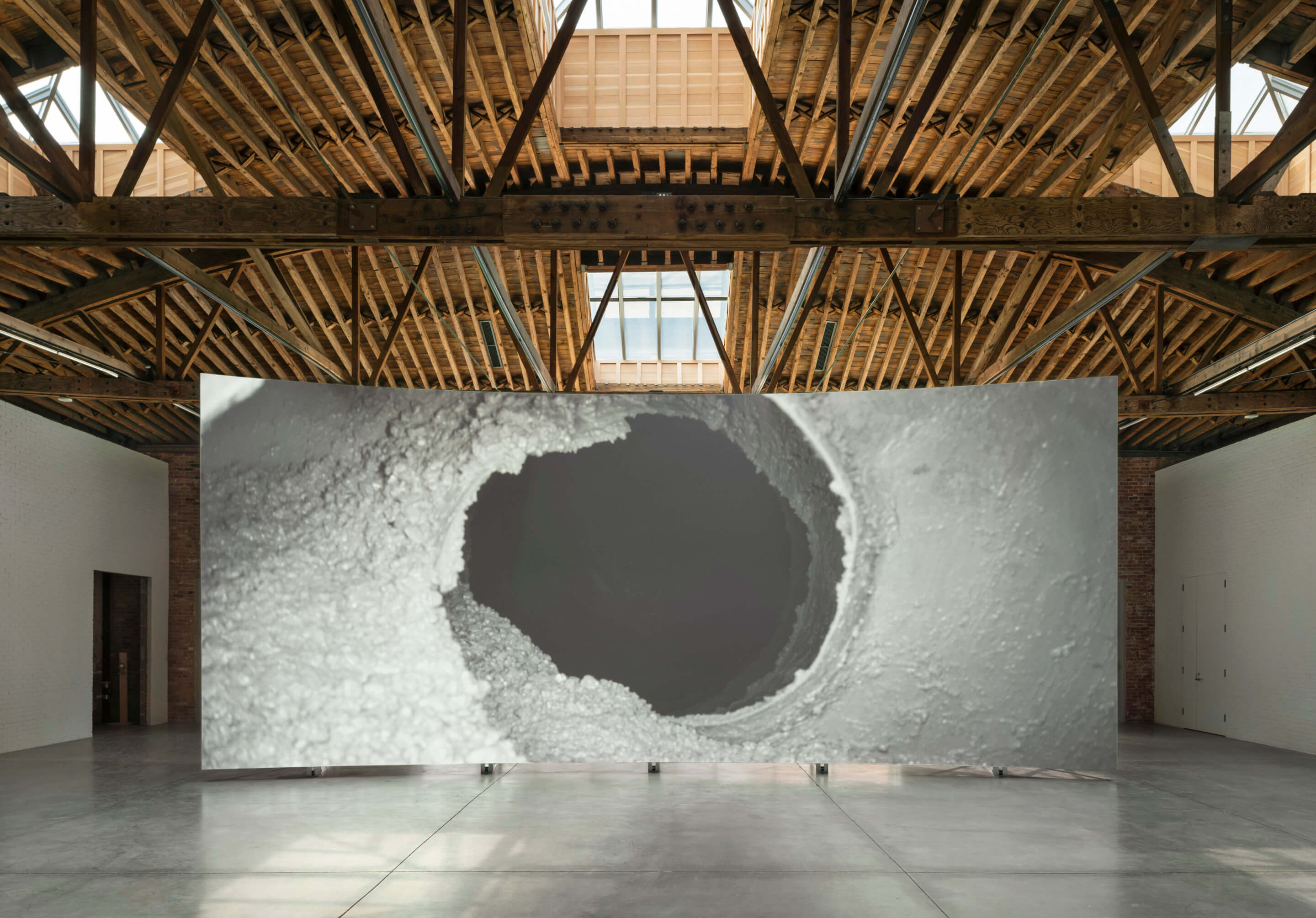 installation view of a major art work beneath a vaulted timber ceiling