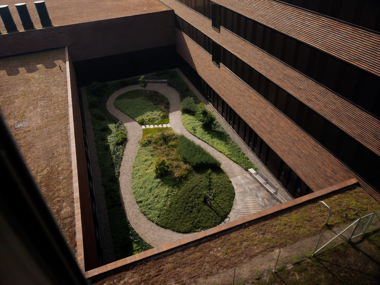 green internal courtyard surrounded by brick