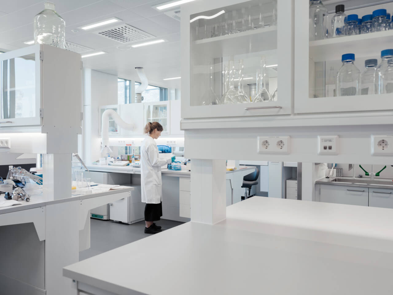 researchers work in a modern lab space