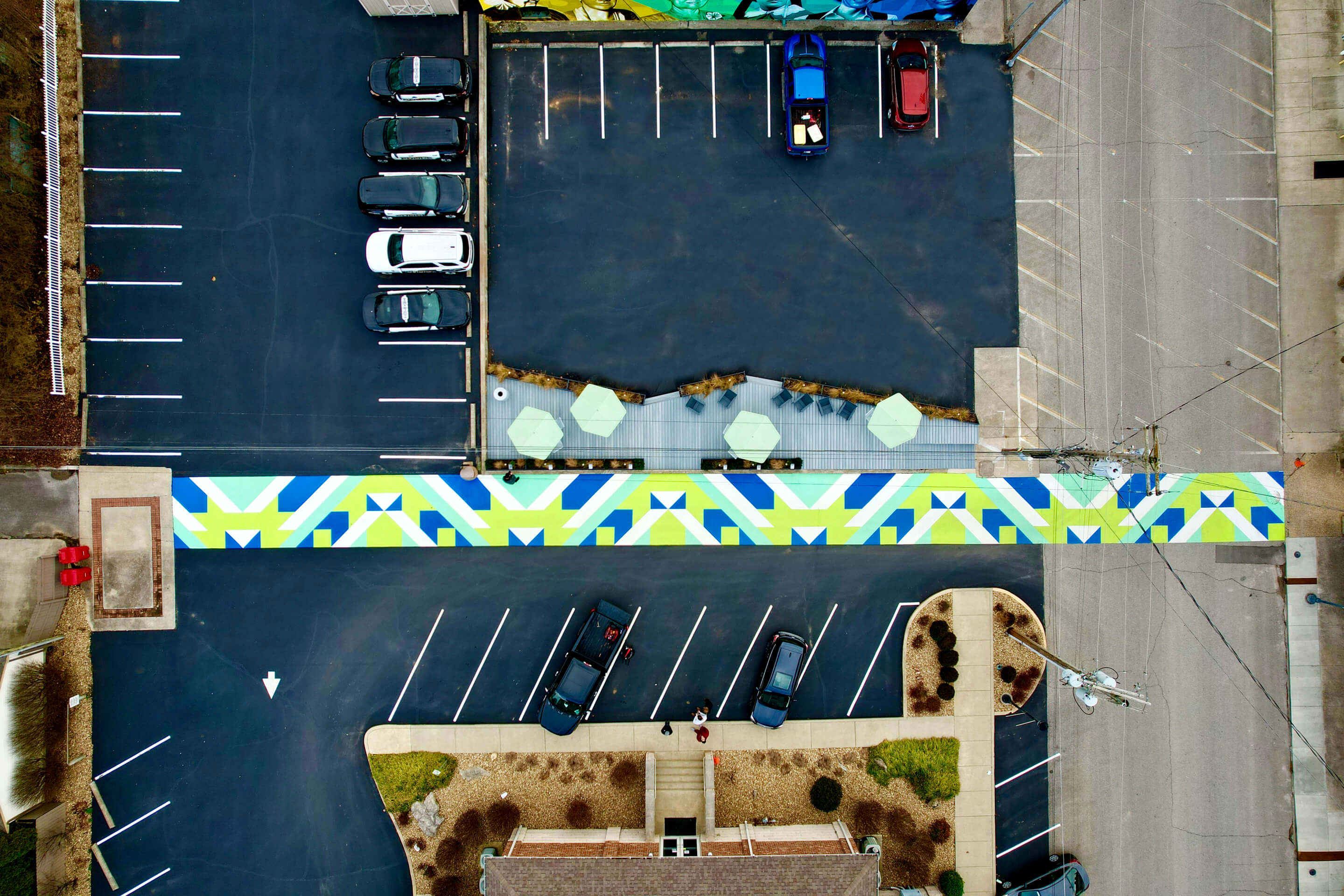aerial view of a linear mural-path and pocket park in a parking lot